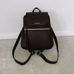 Brand New With Tags! Calvin Klein Cute Backpack Purse Originally $170, Never Used(Has No Flaws, My Mirror Is Just A Little Dusty) Elegant Calvin Klein Brown Shoulder Bag, Elegant Brown Calvin Klein Bag, Calvin Klein Bags Backpacks, Calvin Klein Wallet, Modern Calvin Klein Bags With Silver-tone Hardware, Calvin Klein On-the-go Bags With Zipper Closure, Mesh Backpack, Calvin Klein Bag, Tommy Hilfiger Shoes