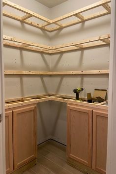 an unfinished kitchen with wooden shelves and cabinets