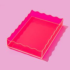 an empty pink box with scalloped edges on a purple background, it appears to have been cut out