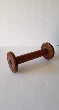 an old wooden handle on a white surface