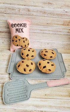 cookie mix cookies on a baking tray with a spatula and pillow next to it