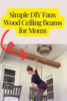 a woman standing on top of a chair in front of a ceiling fan with the words simple diy faux wood ceiling beams for moms