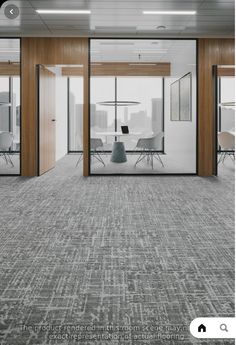 an empty conference room with glass walls and chairs