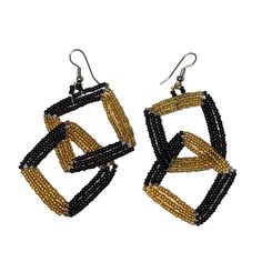 Beautiful square black and gold two tier beaded authentic earrings hand made by the Maasai women in Tanzania. Made out of Maasai glass beads and wire. We directly work with Maasai artisans to produce and market high-end beaded jewelry based on traditional beading techniques infused with modern aesthetics. Maasai women are skilled artisans who are worldwide known for their use of colorful beads. Maasai culture is highly patriarchal and it is the women who are hurt the most by issues of structural Festive Black Jewelry With Colorful Beads, Traditional Black Beaded Earrings For Party, Handmade Elegant Rectangular Beaded Earrings, Elegant Handmade Beaded Rectangular Earrings, Elegant Handmade Rectangular Beaded Earrings, Yellow Rectangular Beaded Jewelry, Traditional Black Earrings With Large Beads, Black Rectangular Beaded Jewelry, Gold Square Beaded Jewelry