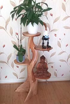 there is a small tree with buddha statues on it