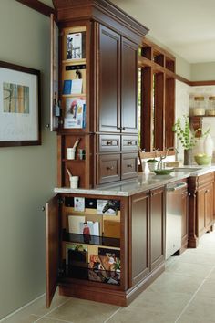 a kitchen with wooden cabinets and marble counter tops