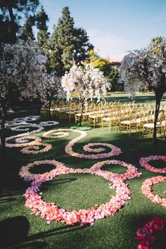 an outdoor ceremony with flowers on the grass