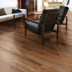 a living room filled with furniture and wooden floors