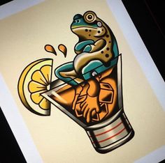 a frog sitting on top of a glass filled with orange juice and lemon wedges