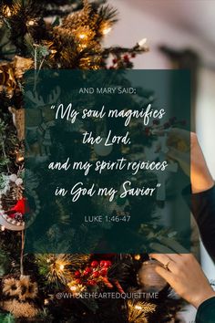 a woman holding up a christmas tree with the words, and mary said my soul magfies