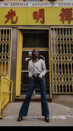 a woman standing in front of a building