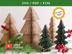 three paper christmas trees with red berries and greenery