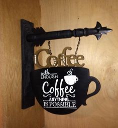 a sign that says coffee with enough coffee anything is possible hanging on a wall next to a hook