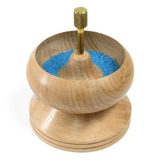 a wooden mortar and pestle with blue powder in it