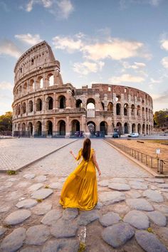 a woman in a yellow dress is looking at the colossion