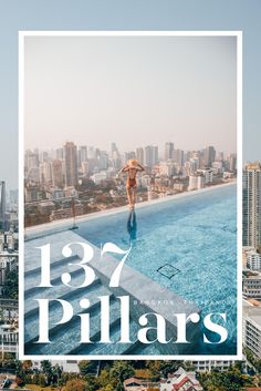 a man standing on the edge of a swimming pool in front of a cityscape