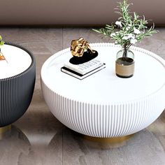 two white tables with plants on them in front of a wall and flooring area