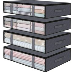 three storage bins stacked on top of each other with folded blankets in them and one opened