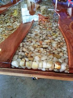 a wooden table topped with lots of rocks and wood planks on top of it