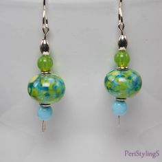 "These cheerful earrings are like a breath of Spring air! The focal beads made by a Georgia USA artist, have lovely shades of fern green and sky blue. Below are Cz glass sky blue round beads and above are Cz glass mantis green round beads. Set off with silver accents, the earrings hang 2\"(5 cm) from the top of the sterling silver handmade ear wires to the tip of the silver paddle pins. Comes in a beautiful gold or silver gift box, wrapped in a white iridescent fabric bag. Ready for gift giving, Green Beaded Earrings With Round Beads, Green Round Beads Jewelry For Summer, Hypoallergenic Beaded Earrings With Round Beads For Summer, Summer Green Jewelry With Round Beads, Hypoallergenic Green Round Bead Earrings, Elegant Green Hypoallergenic Beaded Earrings, Green Czech Glass Beaded Earrings, Green Czech Glass Drop Earrings, Green Beaded Earrings With Czech Glass