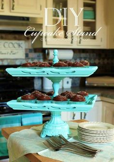 some cupcakes are sitting on a cake stand in the middle of a kitchen