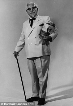 an old man in a suit and tie holding a cane with two books on it