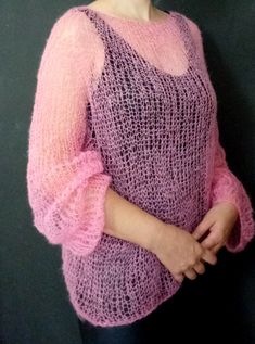 "The pink loose fit sweater features a hand-knitted soft texture with long sleeves. Incredibly soft, enveloping like a cloud will give a feeling of comfort and coziness. Yarn composition: 30% kid mohair, 70% polyamide. Sweater length off shoulder 60 cm (23.6\"), width 65 cm (25.6\"), long sleeve 70 cm (27.5\") Size: S/XL Model's height is 5.6 ft. Chest circumference 37.4\" Hand wash with shampoo is recommended." Cozy Pink Mohair Sweater, Pink Long Sleeve Knitting Pattern, Handmade Long Sleeve Pink Sweater, Handmade Pink Long Sleeve Sweater, Oversized Hand-knitted Pink Sweater, Hand Knitted Pink Mohair Sweater, Pink Hand Knitted Long Sleeve Sweater, Transparent Sweater, Mohair Sweaters