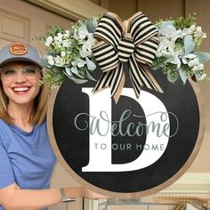 a woman standing next to a welcome sign