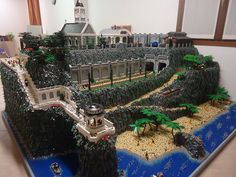 a model of a castle made out of legos on display in a room with white walls