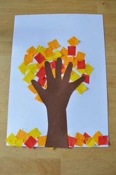 a handprinted tree made out of colored paper