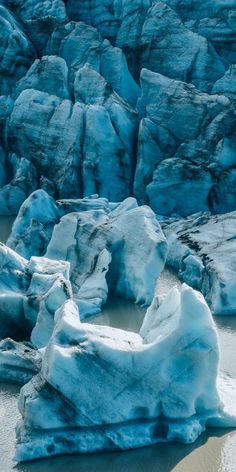 an iceberg in the water with rocks and snow on it's sides, as seen from above