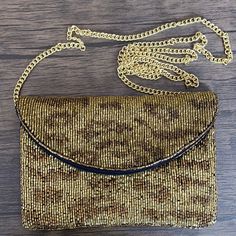 This chic mini clutch features a gold cheetah pattern and a gold strap for a wild and stylish look. Perfect for going out, this clutch bag is a great way to bring your essentials while looking fashionable. Measurements: 7”L x 0.5”W x 5”HChain Strap Measurement: 45” Trendy Brown Evening Bag For Party, Brown Party Clutch With Chain Strap, Evening Shoulder Bag In Leopard Print With Detachable Strap, Leopard Print Shoulder Bag With Detachable Strap For Evening, Evening Leopard Print Shoulder Bag With Detachable Strap, Trendy Brown Clutch For Party, Gold Shoulder Bag With Adjustable Strap For Party, Gold Evening Bag With Chain Strap, Chic Gold Evening Bag With Adjustable Strap