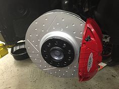 the front brake of a motorcycle with red rotors on it's wheels and brakes