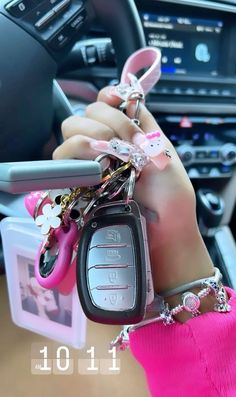 a person holding keys in their hand while sitting in a car