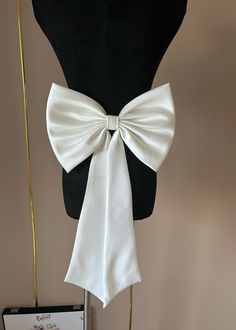 Friends, welcome to my store.     If you are unsure of the colour, please purchase a colour sample from this link https://www.etsy.com/uk/listing/1601619992/additional-fees              Removable wedding bow made of high-grade soft satin.                    The bow comes with fixing pins so it can be easily fixed in different places and you can create your own bridal design.                    All our products are handcrafted using the highest quality fabrics. When it comes to choosing a color, Elegant Bridal Accessories With Satin Bow, Elegant White Hair Accessories With Decorative Bow, Satin Bow With Bow Tie Back For Gifts, Elegant Ribbon Sashes As Gifts, White Bridal Accessories With Satin Bow For Party, Detachable Bow Satin Bow Tie For Party, Party Satin Bow Tie With Detachable Bow, Satin Bow Tie With Ribbon For Party, Formal White Bow With Butterfly Knot