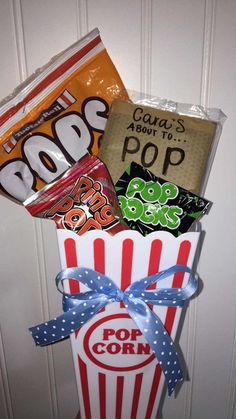 a popcorn box filled with assorted candy and candies on top of a door