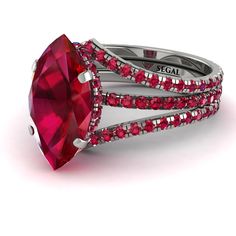 a ring with red stones on it and two bands around the band, in white gold