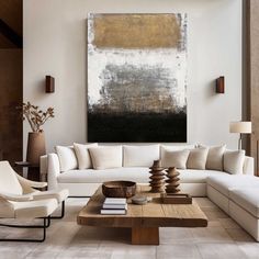 a living room filled with furniture and a large painting on the wall above it's coffee table