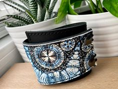 "I've made this wrapping cuff out of smooth leather with a digital print design. Choose from a brown or black leather base. It has attached elastics that hook over two rivets so this cuff will adjust to fit most wrist sizes 6 to 7.5\" in circumference. The cuff is 2\" wide at the narrowest and 2.75\" at the widest end. This cuff is quite unique, I get lots of feedback comments such as: \"I have hard to fit wrists and it fits perfectly.\" \"The leather is so soft and feels great on my skin.\" \"B Adjustable Cuff Bracelet Gift, Blue Adjustable Unique Cuff Bracelet, Handmade Blue Leather Bracelet For Festival, Adjustable Blue Leather Bracelet As Gift, Adjustable Blue Leather Bracelet Gift, Adjustable Blue Leather Bracelet For Festivals, Handmade Blue Leather Festival Bracelet, Adjustable Cuff Wristband As Gift, Adjustable Blue Cuff Bracelet For Festivals