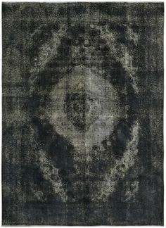 a black and white area rug with an abstract design on the center, in grey tones