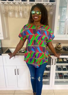 Beautiful African print top for women with African fabric 100% cotton. This colorful Ankara summer blouse is versatile, flattering, and available for all sizes including plus sizes. Ankara blouse with split neckline. African shirt for women with side slits, pleats, and a fun curved hem.  Wear this African top over pants, skirts, shorts, or jeans, and cinch it with your own belt for a different look- see all the inserted photos. This item will be specially handcrafted for you upon purchase. 🛑 Accessories & head tie on model are not included, please click below to purchase a matching head tie. https://www.etsy.com/listing/756336810/africa-head-wrap-ankara-headwraps?click_key=015272619699118e8d91495eb65f63fd178c2c77%3A756336810&click_sum=eb658d78&ref=shop_home_active_1 *️⃣ MEASUREMENT GUIDE: Cotton Short Sleeve Shirt With Vibrant Print, Vibrant Print Short Sleeve Cotton Shirt, Relaxed Fit Multicolor Cotton Blouse, Short Sleeve Cotton Shirt With Vibrant Print, Colorful Pattern Cotton Top With Short Sleeves, Multicolor Short Sleeve Tops For Vacation, Beach Cotton Shirt With Vibrant Print, Relaxed Fit Multicolor Patterned Top, Casual Multicolor Cotton Blouse