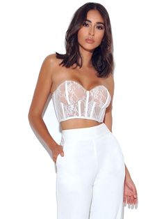 Keep it chic in this white lace corset crop top! This fully lined strapless stretch lace top is perfect for adding a touch of glam to any look. The nude lining and zippered back add subtle detailing. Pair with our easy to wear Never Enough Wide Leg Trouser for a flattering weekend look! (sold separately). Available in white and black. Materials: Lace / Stretch Mesh / Boned Corset Length: Approx 6 inch / 15 cm Stretch Factor: Low Stretch Clean: Dry-clean only Model Is Wearing A Size XS (US-2) Mod White Lace Corset, Stretch Lace Top, Miss Circle, White Lace Crop Top, Top Bustier, Lace Corset Top, Corset Bustier, Corset Crop Top, New Romantics