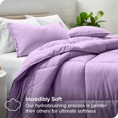 an image of a bed with purple comforter and pillows on the bottom, text reads incredibly soft our hydrobrushing process is gentle than others for ultimate softness