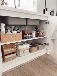 the shelves in this kitchen are organized with baskets and containers for items to be put on