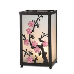 a lamp with pink flowers on it and a black frame around the light bulb,