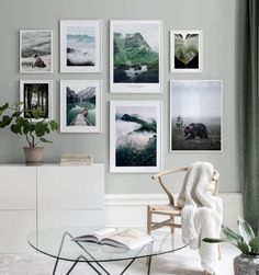 a living room with pictures on the wall and a chair in front of a coffee table