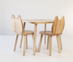 two children's wooden chairs and table with cat ears on the backrests