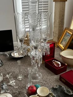 an assortment of glassware and other items on a table