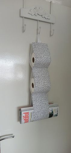 two rolls of toilet paper are hanging on the wall