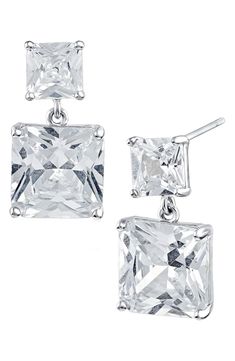 Large and small emerald cut cubic zirconia stones create elegant dangle earrings that add subtle glam to your look. 0.75" length Post back Brass/cubic zirconia Imported Cz Drop Earrings, Silver Square Cut Cubic Zirconia Earrings, Elegant Silver Asscher Cut Earrings, Subtle Glam, Eco Brand, Cut Earrings, Sustainable Brand, Kenneth Jay Lane, Personal Shopping